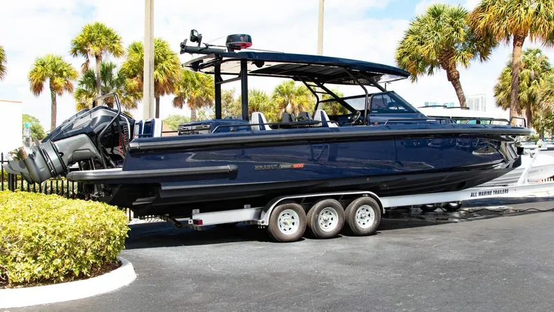Slide: The Image of 2023 BRABUS Shadow 900 ST boat on a trailer, parked near palm trees. - 20