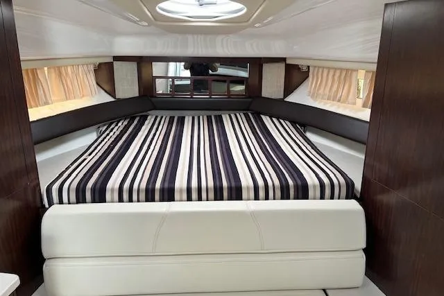 Slide: The Image of Interior cabin of 2019 Monterey 355 Sport Yacht with striped bedding and modern design. - 19