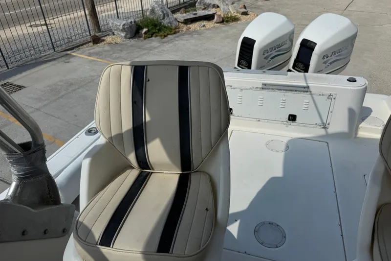 Slide: The Image of 1997 Hydra-Sports VECTOR 2650 WA boat interior with striped seating and dual Evinrude engines. - 12