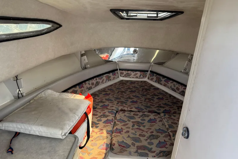 Slide: The Image of 1997 Hydra-Sports VECTOR 2650 WA cabin interior with patterned cushions and overhead hatch. - 13