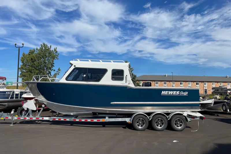The Image of 2026 Hewescraft 270 Alaskan ET HT boat on trailer under blue sky. - 0