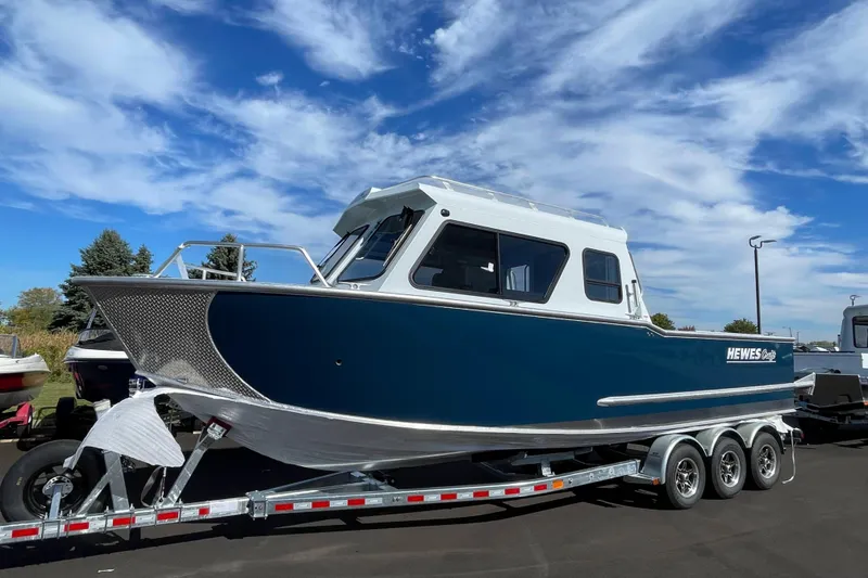 Slide: The Image of 2026 Hewescraft 270 Alaskan ET HT boat on trailer under blue sky. - 1