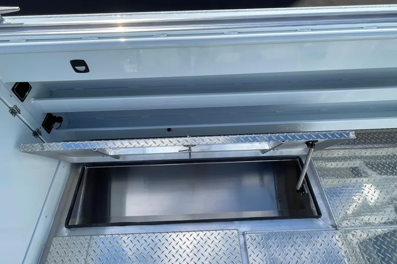 Slide: The Image of 2026 Hewescraft 270 Alaskan ET HT boat storage compartment with diamond plate flooring. - 12
