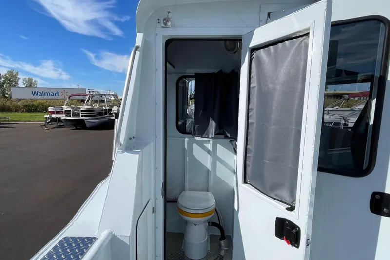 Slide: The Image of 2026 Hewescraft 270 Alaskan ET HT boat with open cabin door and visible toilet. - 14