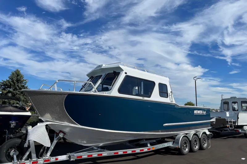 Slide: The Image of 2026 Hewescraft 270 Alaskan ET HT boat on trailer under blue sky. - 2