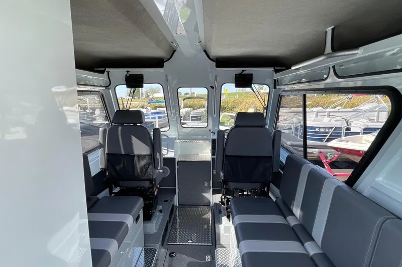 Slide: The Image of Interior of 2026 Hewescraft 270 Alaskan ET HT boat with seating and windows. - 20