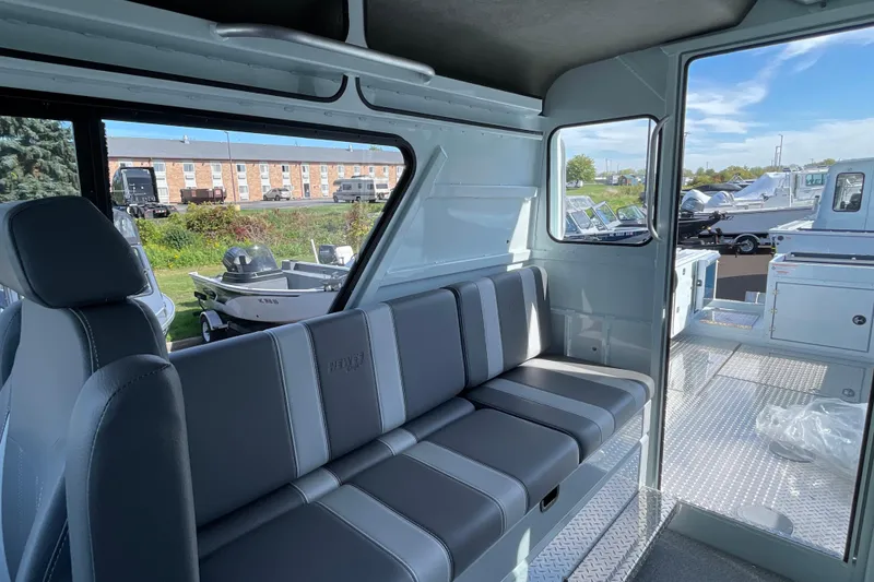 Slide: The Image of Interior of 2026 Hewescraft 270 Alaskan ET HT boat, featuring gray seating and spacious cabin. - 25