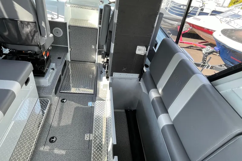 Slide: The Image of Interior of 2026 Hewescraft 270 Alaskan ET HT boat, featuring seating and storage. - 29