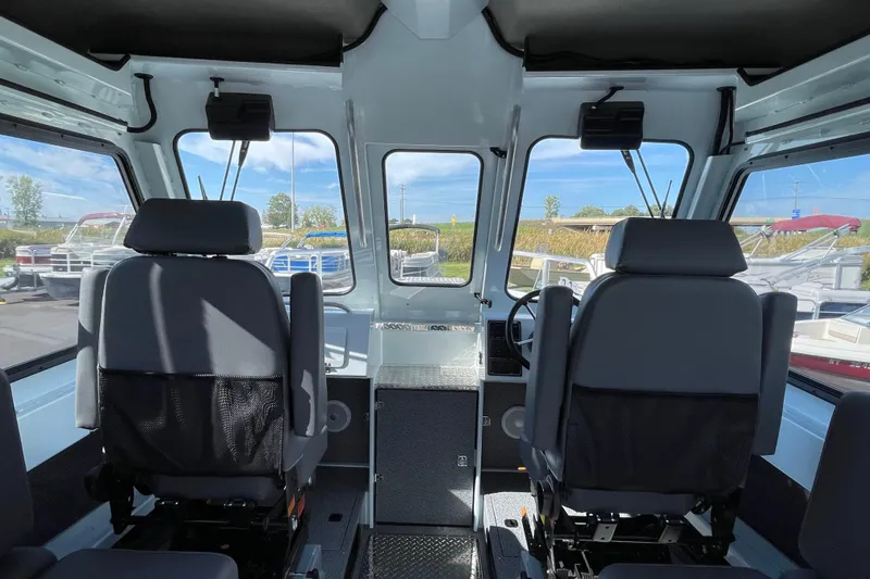 Slide: The Image of Interior of 2026 Hewescraft 270 Alaskan ET HT boat with seating and dashboard. - 30