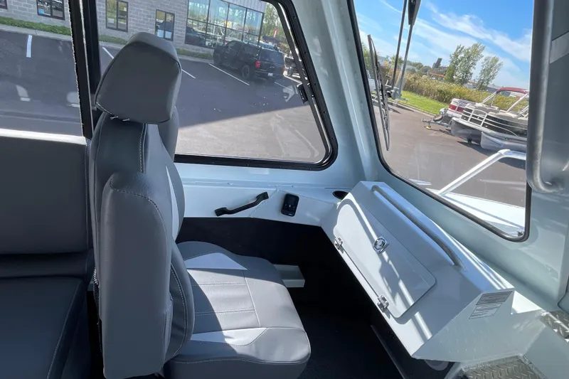 Slide: The Image of Interior of 2026 Hewescraft 270 ALASKAN ET HT boat, featuring seating and dashboard. - 32