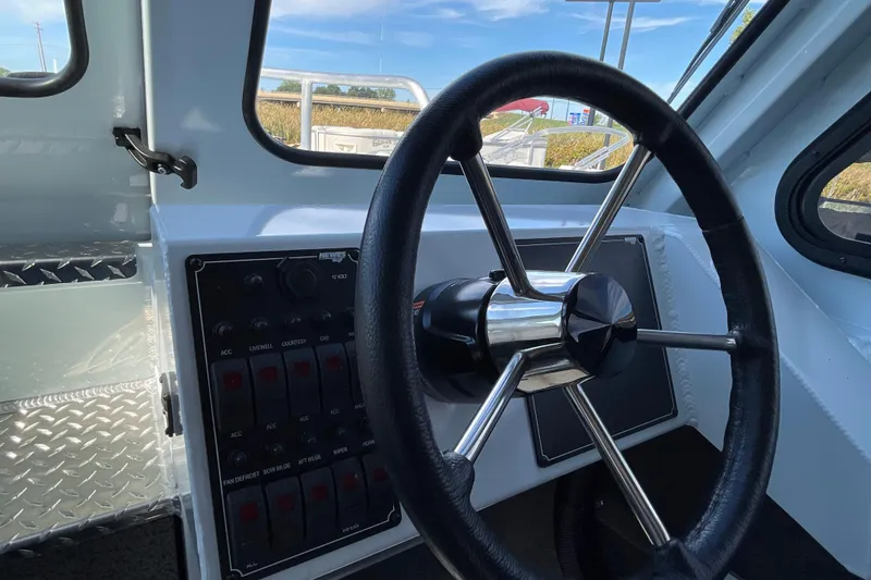 Slide: The Image of 2026 Hewescraft 270 Alaskan ET HT boat steering wheel and control panel. - 35