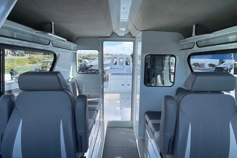 Slide: The Image of Interior of 2026 Hewescraft 270 ALASKAN ET HT boat with modern seating and windows. - 39