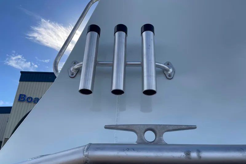 Slide: The Image of 2026 Hewescraft 270 Alaskan ET HT boat with rod holders and cleat against blue sky. - 43