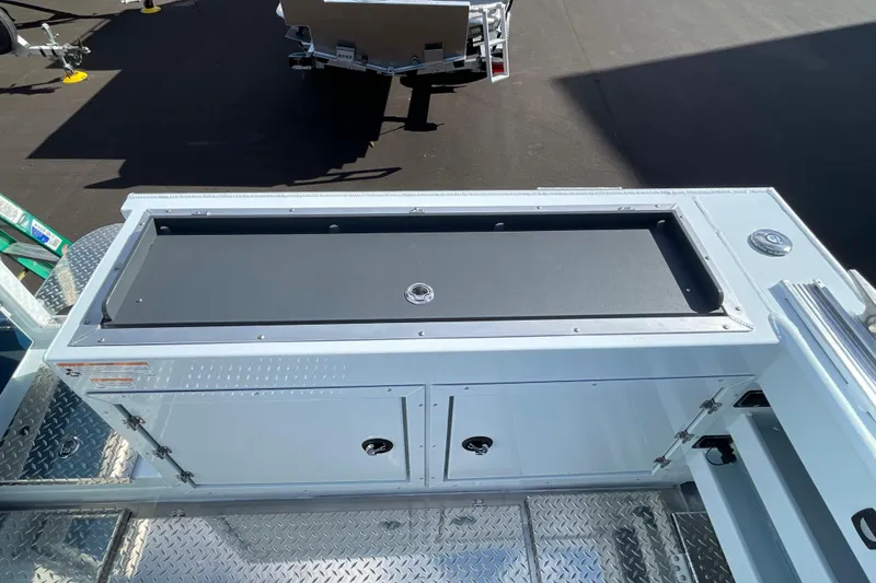 Slide: The Image of 2026 Hewescraft 270 ALASKAN ET HT boat deck with storage compartments. - 8