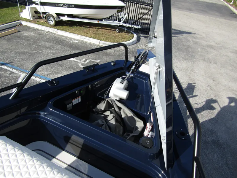 Slide: The Image of 2024 BRABUS Shadow 900 ST boat storage compartment with open hatch, docked near trailer. - 6