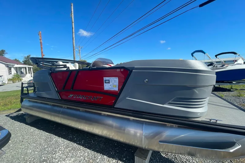 Slide: The Image of 2026 Starcraft GX 18 R pontoon boat displayed outdoors on a sunny day. - 3