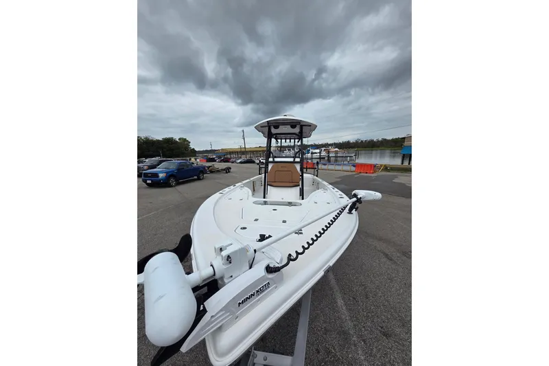 Slide: The Image of 2024 Sea Pro 250 Bay boat docked under cloudy skies. - 10