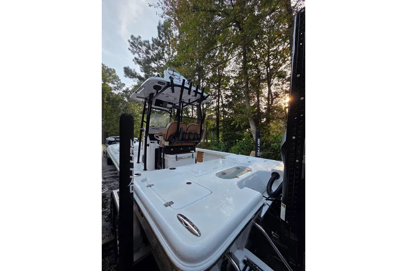 Slide: The Image of 2024 Sea Pro 250 Bay boat in a wooded setting, showcasing sleek design and features. - 11