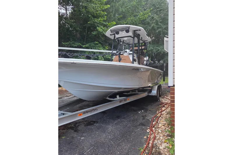 Slide: The Image of 2024 Sea Pro 250 Bay boat on trailer, parked outdoors. - 14