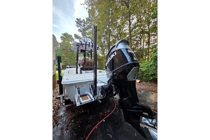 Slide: The Image of 2024 Sea Pro 250 Bay boat with Suzuki outboard motor, parked outdoors. - 3