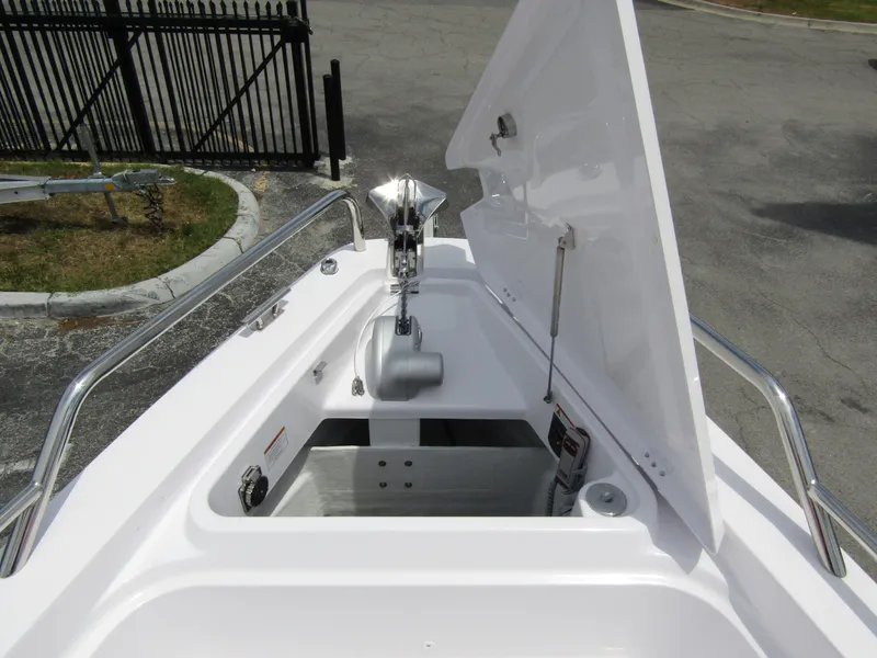 Slide: The Image of 2024 Axopar 37 Sun Top anchor compartment with open hatch, showcasing storage and anchor mechanism. - 10