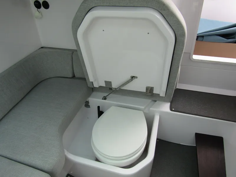 Slide: The Image of 2024 Axopar 37 Sun Top interior with hidden toilet under seat. - 25