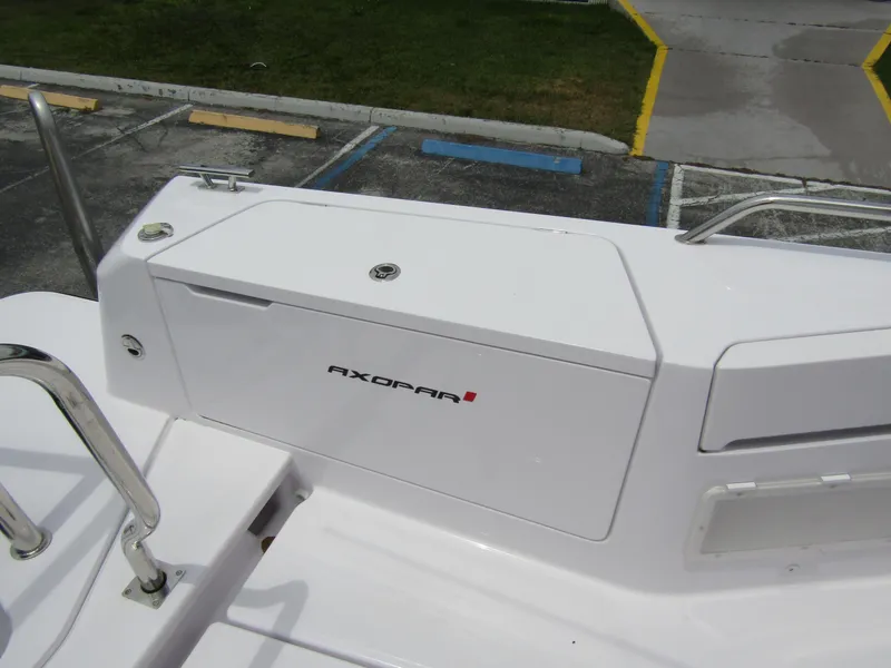 Slide: The Image of 2024 Axopar 37 Sun Top boat detail, featuring sleek white design and branding. - 28
