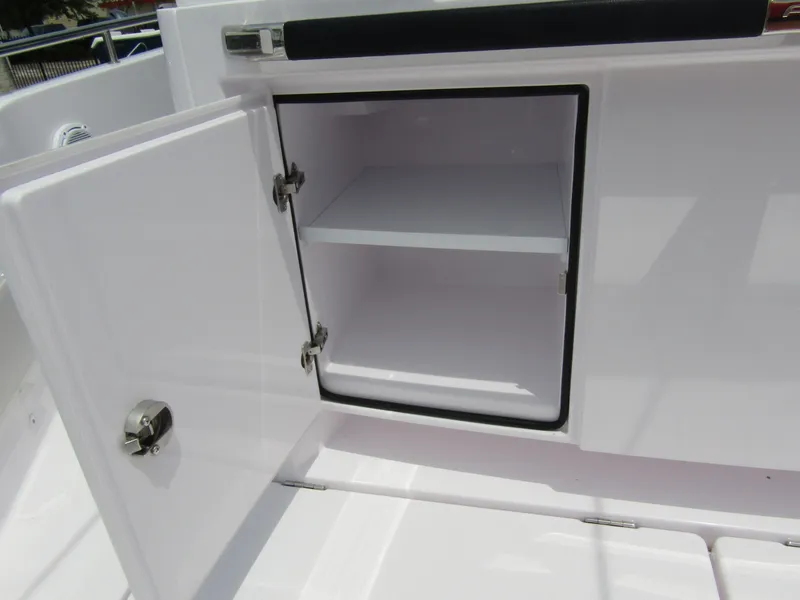 Slide: The Image of Open storage compartment on 2024 Axopar 37 Sun Top boat. - 33