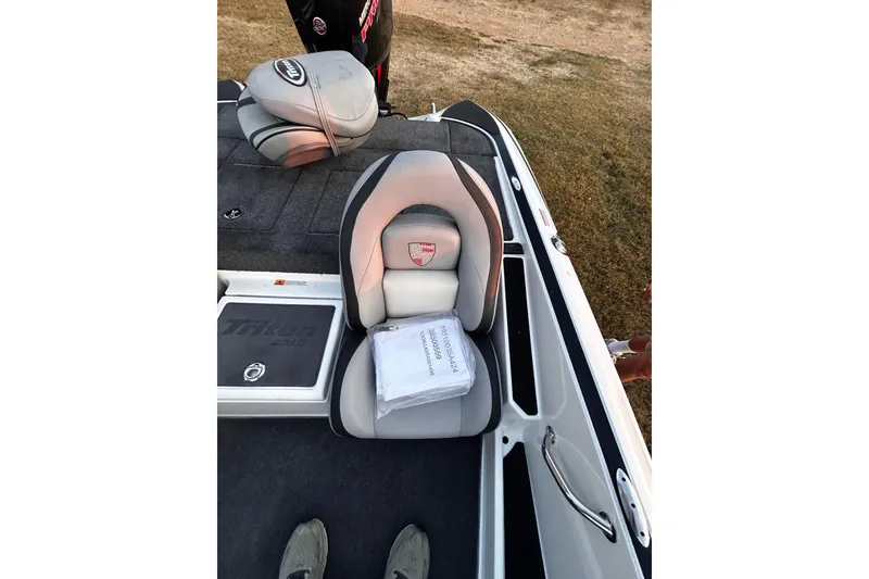 Slide: The Image of 2024 Triton 179 TrX boat interior with cushioned seating and storage compartments. - 11