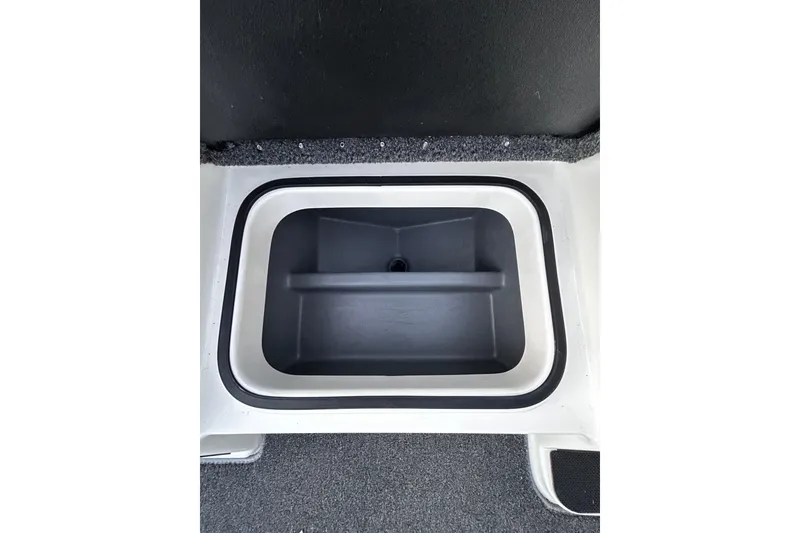 Slide: The Image of 2024 Triton 179 TrX boat storage compartment, black interior, white trim. - 13