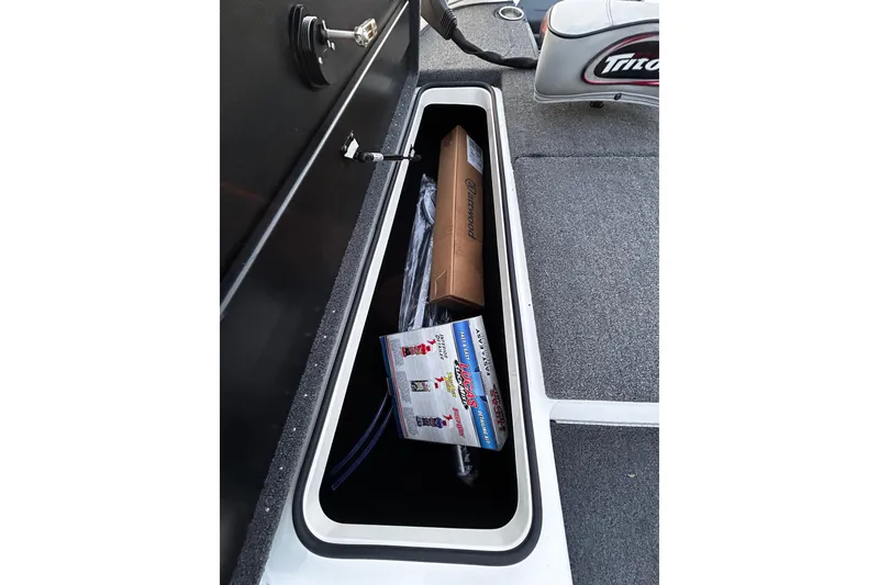 Slide: The Image of Storage compartment of 2024 Triton 179 TrX boat with equipment and supplies. - 14