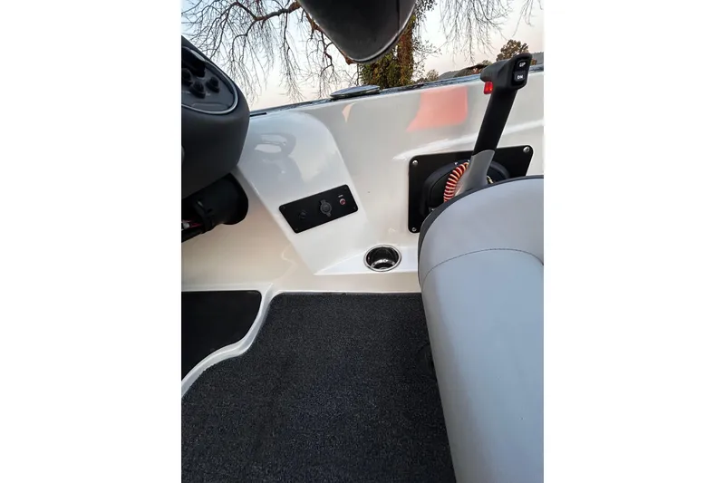 Slide: The Image of 2024 Triton 179 TrX boat interior with control panel and seating. - 5