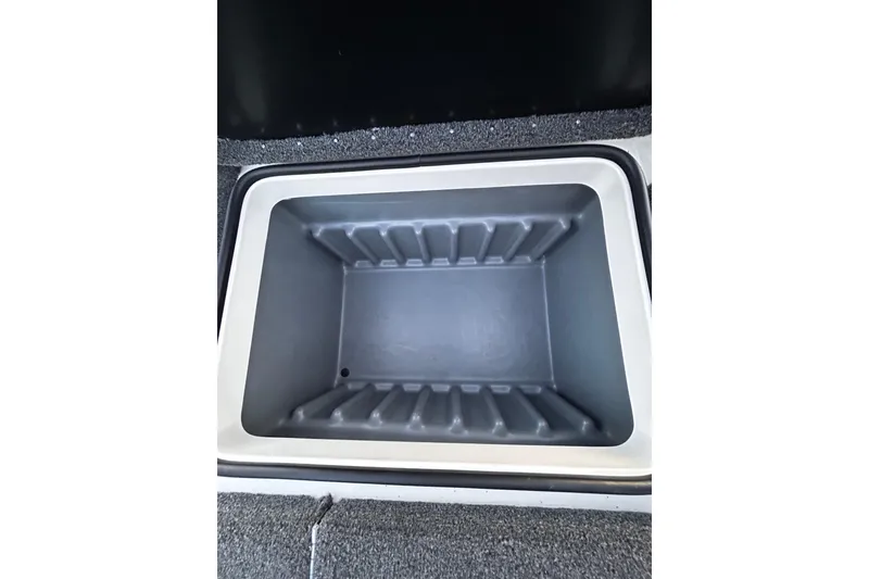 Slide: The Image of 2024 Triton 179 TrX boat storage compartment, open and empty, with textured interior. - 8