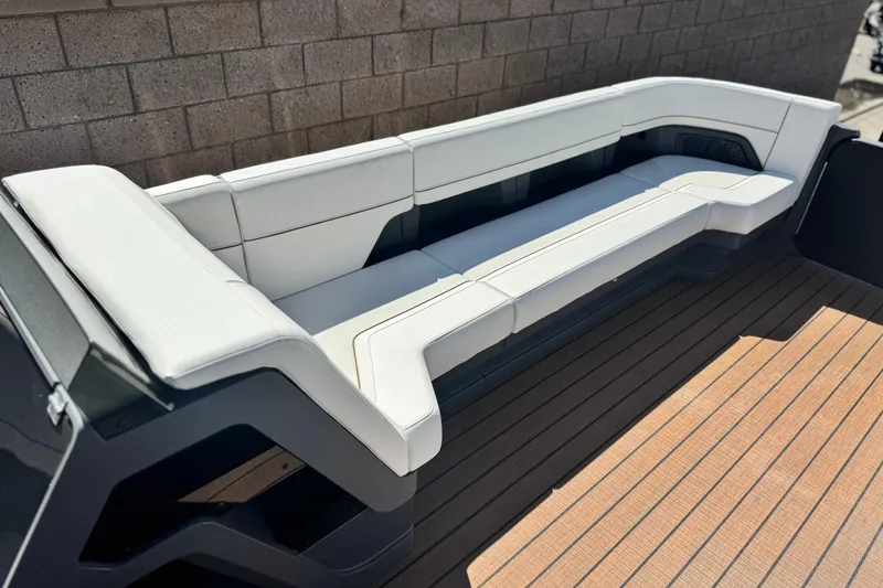 Slide: The Image of Luxurious seating on 2025 Manitou EXPLORE 26 boat, featuring sleek white cushions and modern design. - 10