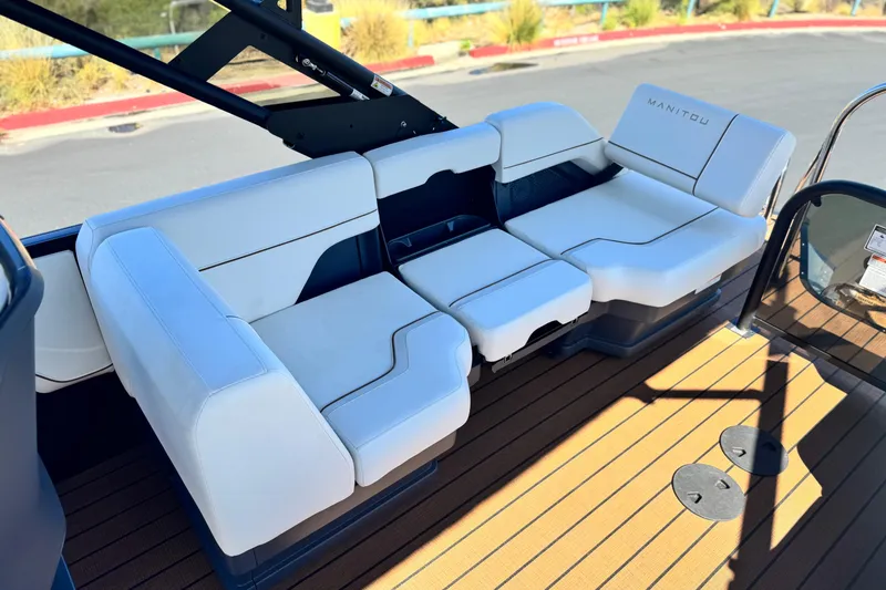Slide: The Image of Luxurious seating on 2025 Manitou EXPLORE 26 boat, featuring sleek white upholstery. - 14