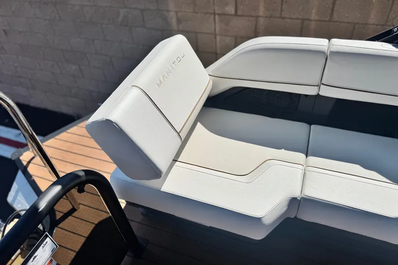 Slide: The Image of Luxurious seating on 2025 Manitou EXPLORE 26 boat, featuring sleek white upholstery. - 17