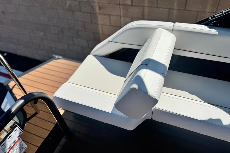 Slide: The Image of Luxury seating on 2025 Manitou EXPLORE 26 boat, featuring white upholstery and sleek design. - 18