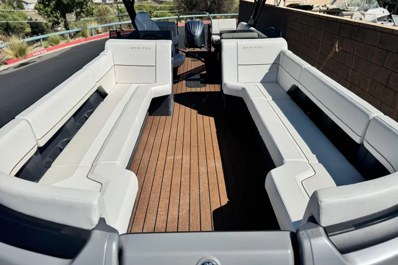 Slide: The Image of 2025 Manitou EXPLORE 26 boat with spacious seating and sleek design. - 8