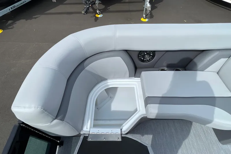 Slide: The Image of 2026 Godfrey Monaco 235 SB boat interior with gray seating and storage compartment. - 12