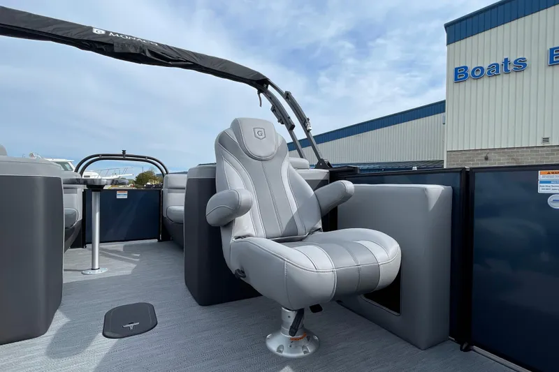 Slide: The Image of 2026 Godfrey Monaco 235 SB boat with luxurious seating at a marina. - 14