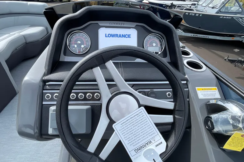 Slide: The Image of Steering console of 2026 Godfrey Monaco 235 SB with Lowrance display and gauges. - 16