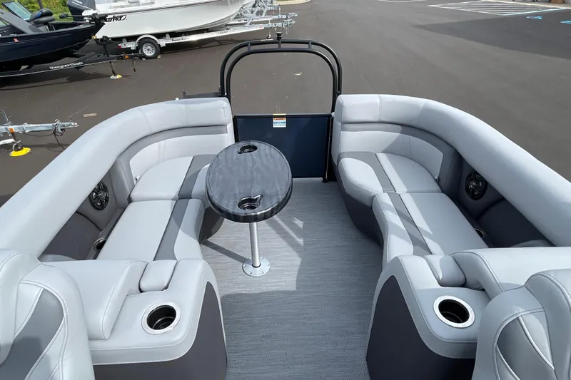 Slide: The Image of 2026 Godfrey Monaco 235 SB pontoon boat interior with gray seating and central table. - 20