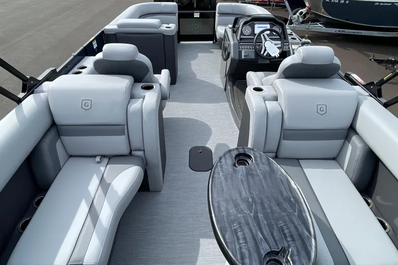 Slide: The Image of 2026 Godfrey Monaco 235 SB pontoon boat interior with luxurious seating and modern dashboard. - 22