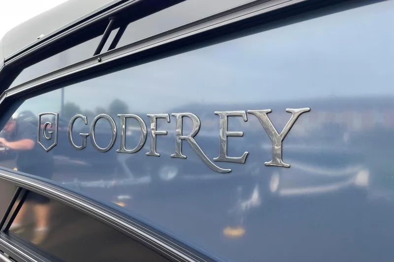 Slide: The Image of Close-up of 2026 Godfrey Monaco 235 SB logo on a sleek blue surface. - 29