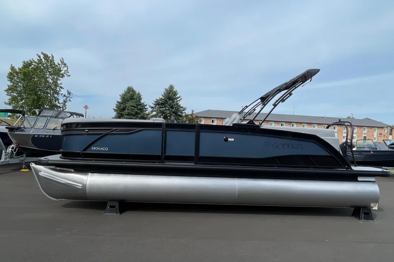 Slide: The Image of 2026 Godfrey Monaco 235 SB pontoon boat displayed outdoors on a sunny day. - 4