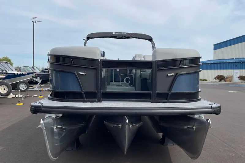 Slide: The Image of 2026 Godfrey Monaco 235 SB pontoon boat, docked, with sleek design and modern features. - 5