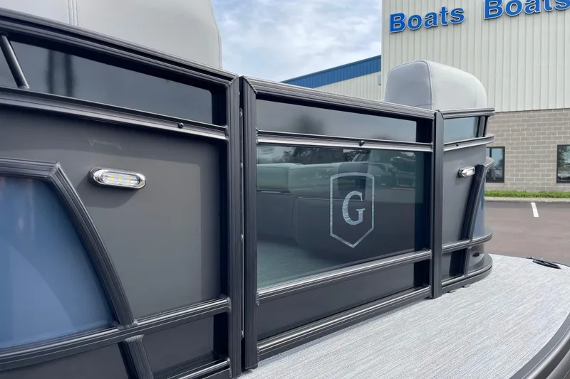 Slide: The Image of 2026 Godfrey Monaco 235 SB pontoon boat exterior with sleek design and logo detail. - 6