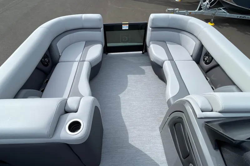 Slide: The Image of Luxurious seating on 2026 Godfrey Monaco 235 SB pontoon boat, featuring sleek gray upholstery. - 9