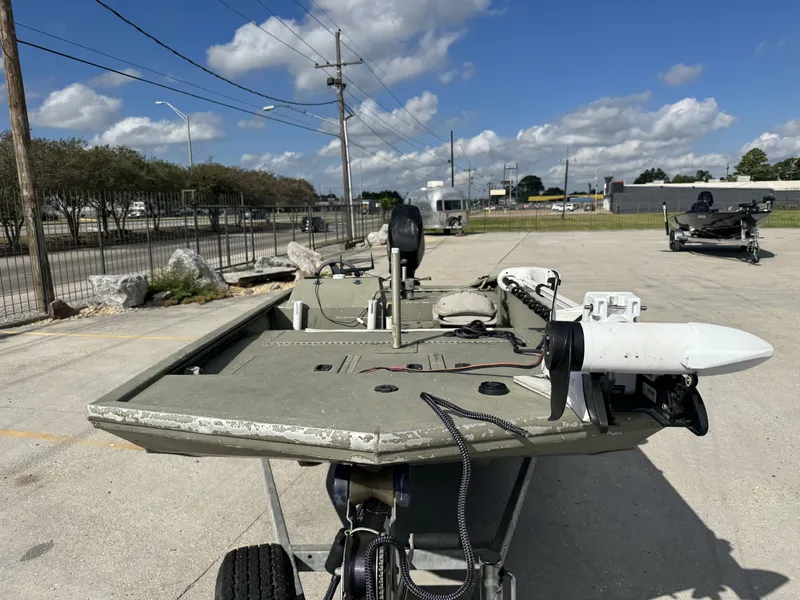 Slide: The Image of 2009 Lowe R1655SC boat on trailer, parked outdoors under blue sky. - 10