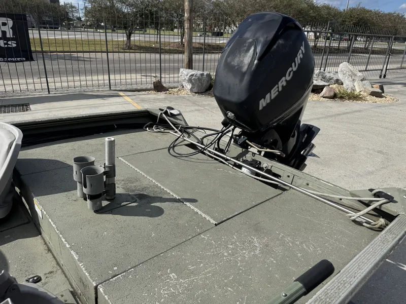 Slide: The Image of 2009 Lowe R1655SC boat with Mercury outboard motor, parked outdoors. - 13